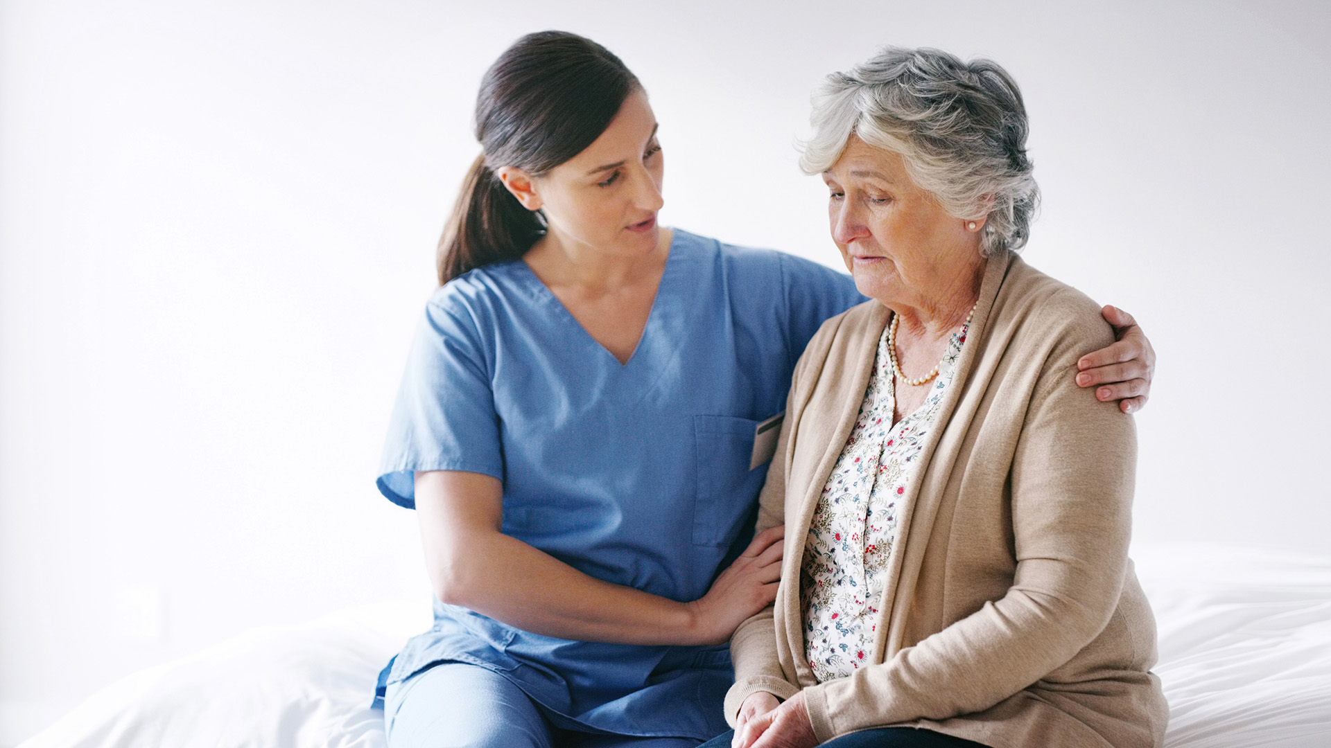 Senior woman receiving assistance from her caregiver