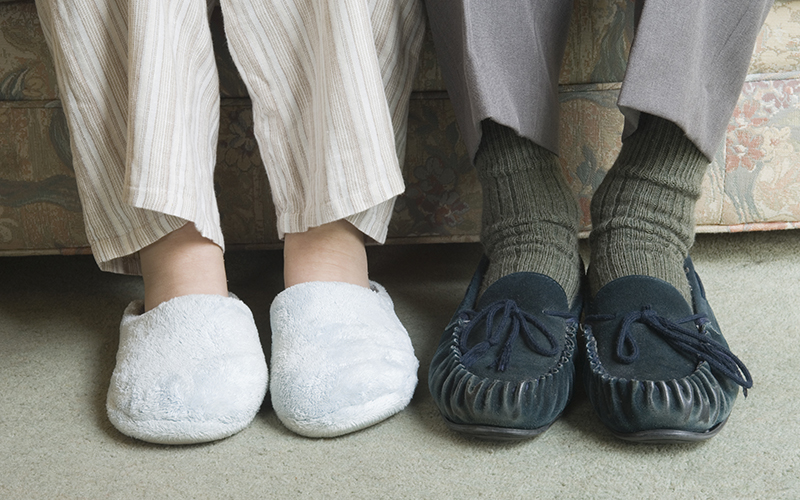 Close-up of a senior couple's feet wearing comfy slippers