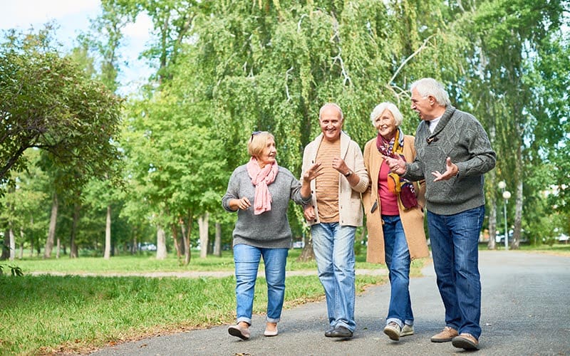 Group of seniors walking together outdoors