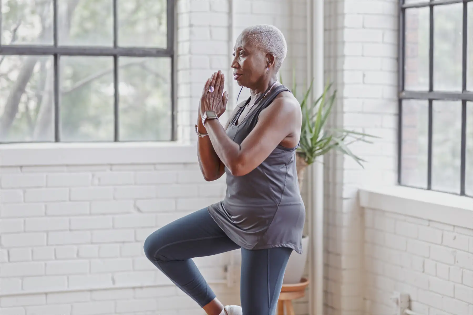 a senior woman holding a Tai Chi pose