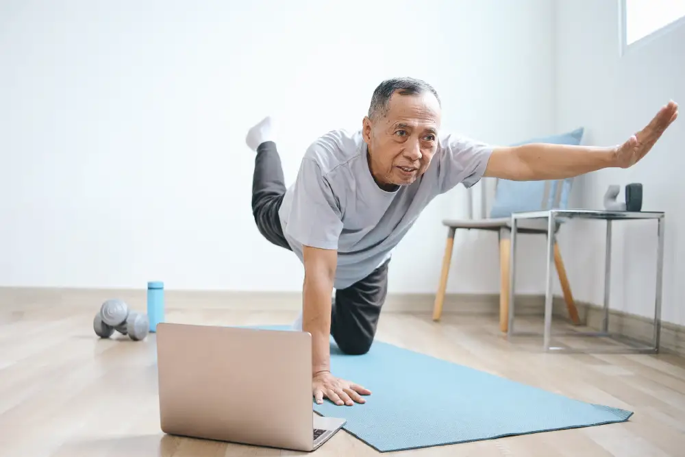 a senior man doing yoga on a yoga mat