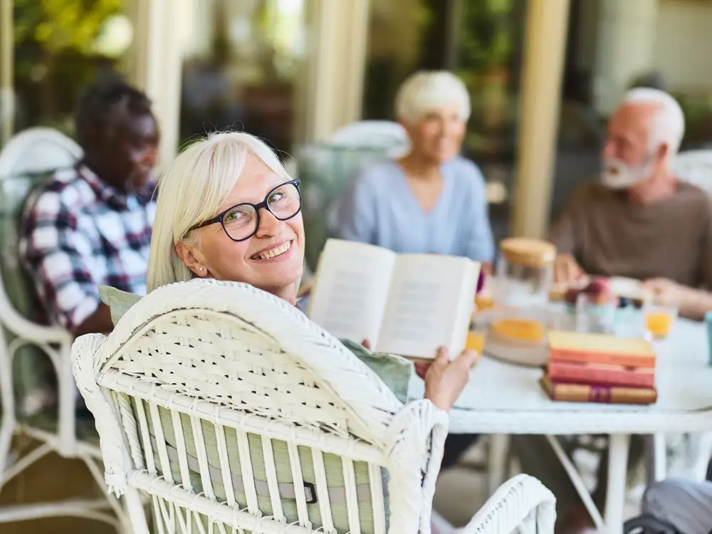 tailored-living The mid adult male counselor visits the lonely senior woman. They sit on the sofa in her living room at Quartet.
