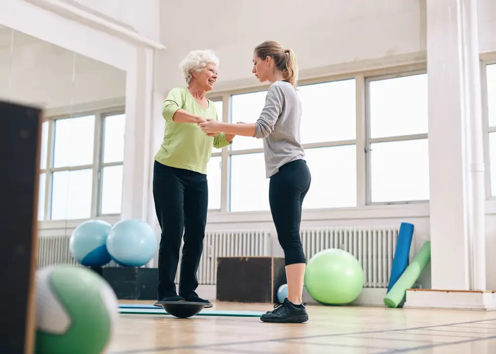 Senior woman doing balance training with therapist at Quartet Senior Living in Bettendorf, Iowa