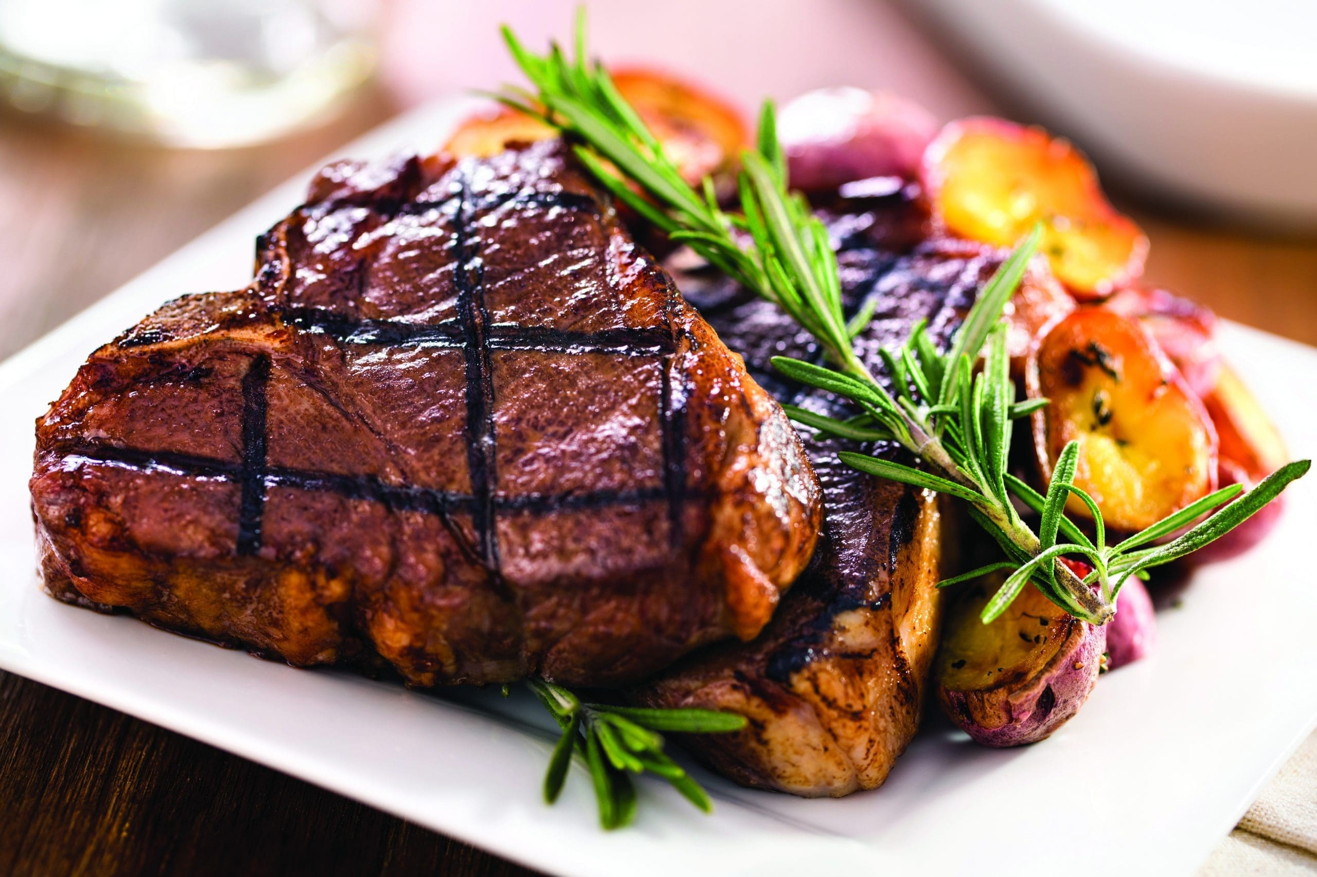 steak-dining-experience-quartet-bettendorf Grilled steak served with roasted vegetables and herbs, showcasing dining options and community life at Quartet Senior Living.