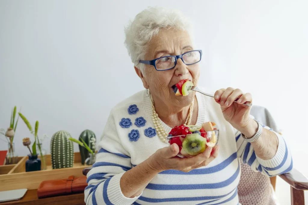 senior woman eating fruit